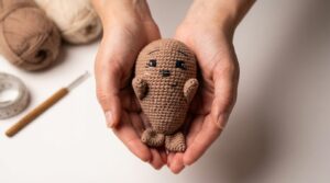 Amigurumi foca bebê de tom suave feito em crochê artesanal ideal como decoração infantil ou lembrancinha encantadora.